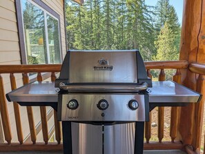 A stainless steel outdoor grill with a brand name, a control panel with knobs, and a flat cooking surface. - Kimberley Mountain Getaway | Ski, Golf & Adventure (Kimberley)