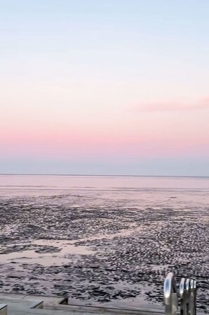 A beach with a calm sea and a clear sky. - Sonnendeck by Interhome (Dornumersiel)
