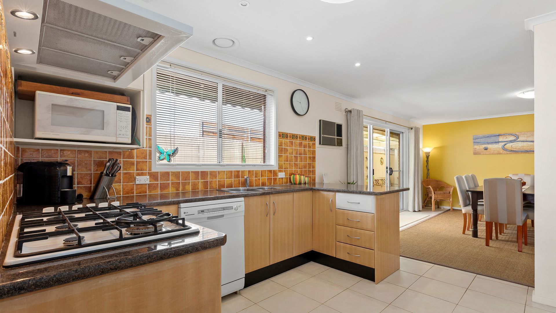 A modern kitchen with a gas stove, microwave, and dishwasher.