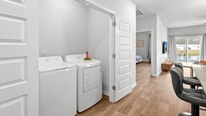A modern kitchen with a large island, built-in appliances, and a view to the outdoors. - LakeView Modern 3BR/3BA Near Beach NewBuild Home Myrtle Beach (Myrtle Beach)