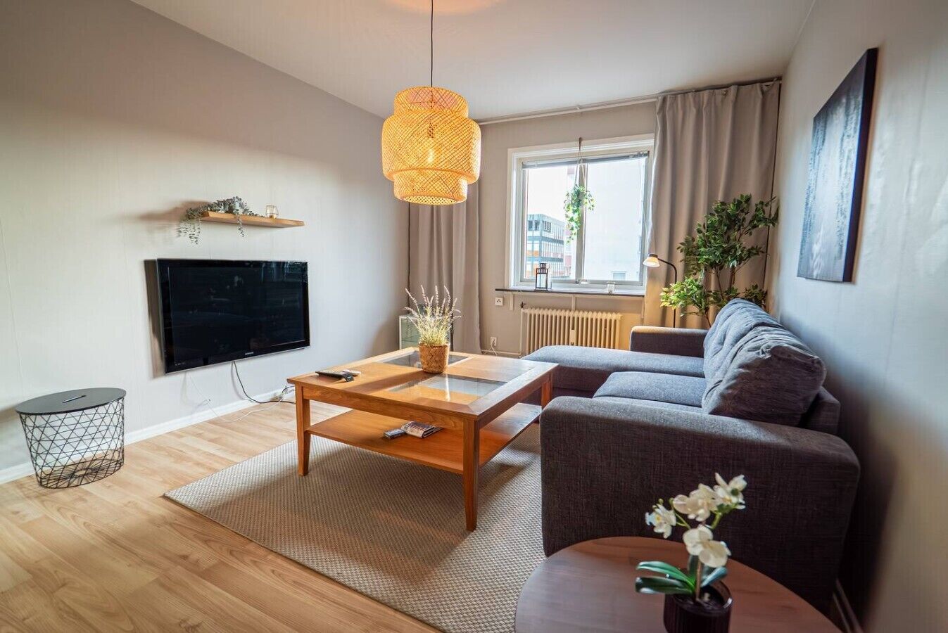 Un salon moderne avec un canapé, une table basse et un téléviseur.