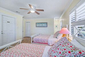 A bedroom with two beds, a ceiling fan, a window with blinds, and a door labeled 'Guest Room'. - WTFR Home with pool, golf cart, large yard (Indian Rocks Beach)