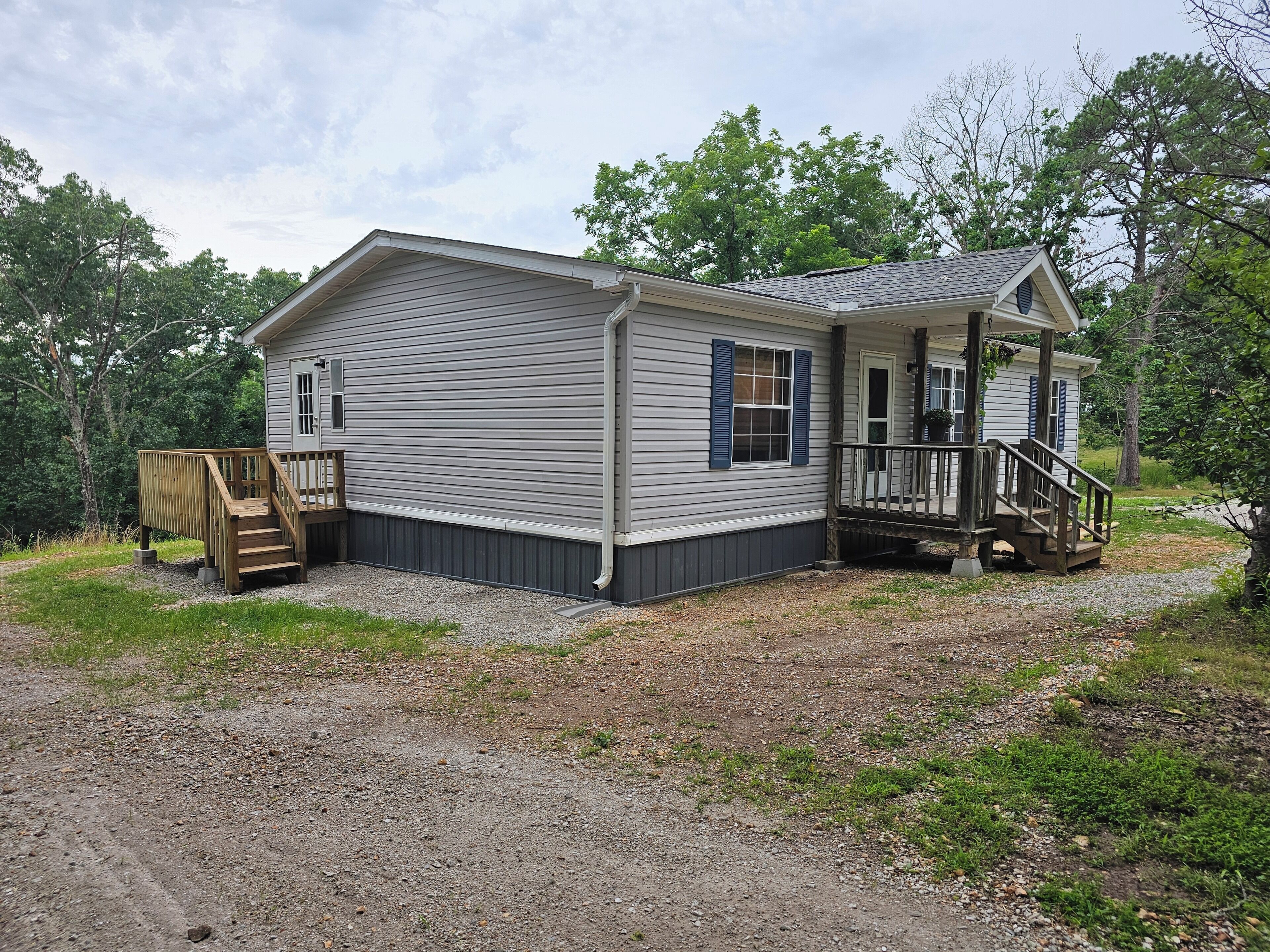 A single-story house with a front porch and a small deck.