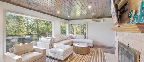 A modern living room with a sectional sofa, a round coffee table, and a fireplace.