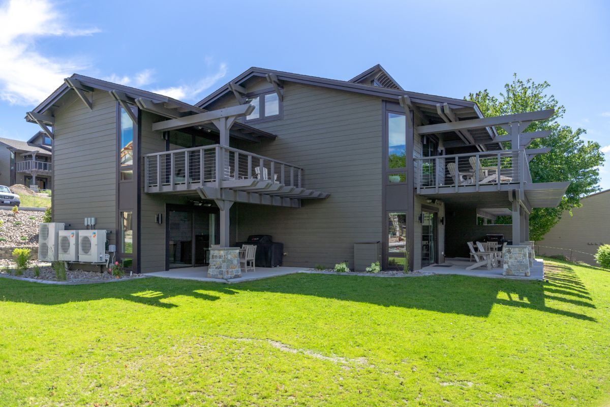 A two-story building with a balcony and a covered outdoor seating area.