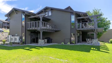 A two-story building with a balcony and a covered outdoor seating area.