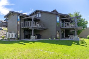A two-story building with a balcony and a covered outdoor seating area. - Yacine Court (Manson)
