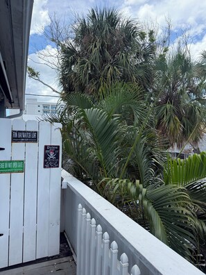 A white fence with signs indicating a private door and a 'Pirates Only' area. - BAYWATCH Loft STEPS to Beach Sleeps 7 Hot Tub FULL Beach Gear (Clearwater)