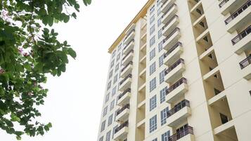 A high-rise residential building with multiple balconies and a uniform facade.
