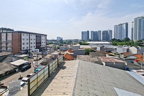 A high-rise building with multiple floors, surrounded by other buildings and a clear sky. - Compact And Homey Studio At Apartment Sky View (Tangerang)