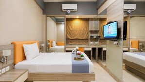 A hotel room with a bed, bedside tables, a TV, and a mirror. - Calming Wooden Touch Studio Room At Apartment Soekarno Hatta (Suhat) Malang (Malang)