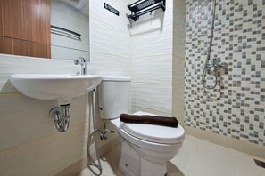 A bathroom with a sink, toilet, and shower. - Warm Wooden Touch Studio Room At Apartment Cisauk Point (Tangerang)