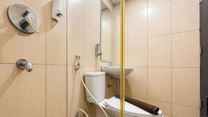 A modern bathroom with a toilet, bidet, and sink. - Comfortable And Practical Living Studio Room At Apartment Tamansari Papilio (Surabaya)