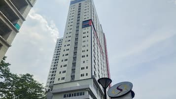 A tall, modern building with multiple floors and a prominent sign for Sahid Serpong.