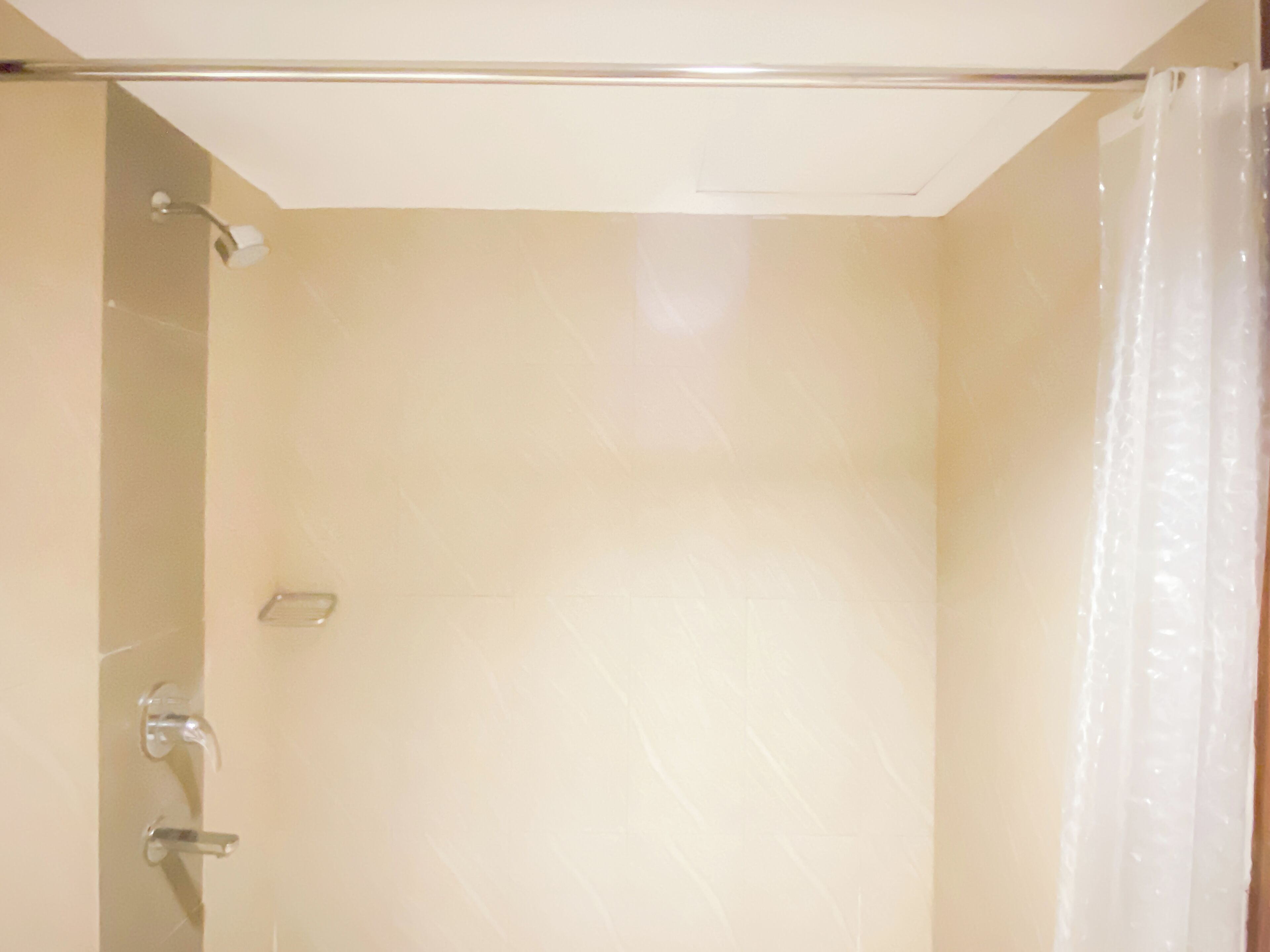 A bathroom with a shower, a toilet, and a sink.