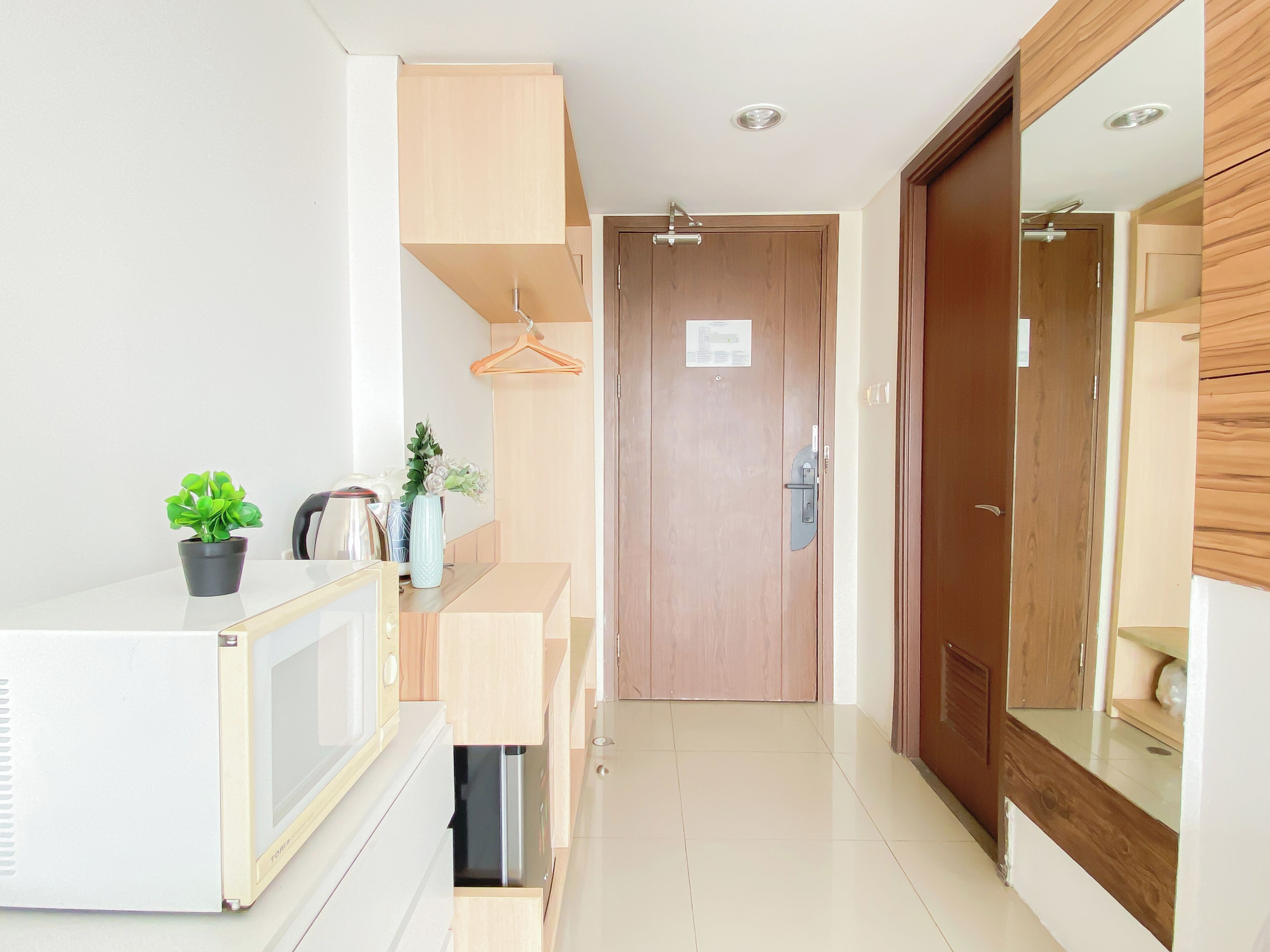 A modern kitchen with a microwave, sink, and cabinets.
