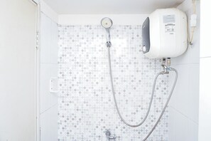 A shower with a handheld showerhead and a wall-mounted control panel. - Best Deal Studio Apartment At Grand Sentraland Karawang (Karawang)