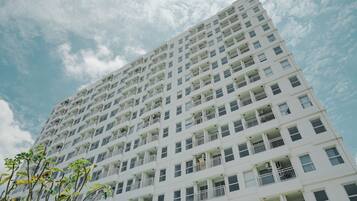 A tall, modern building with multiple balconies and windows.