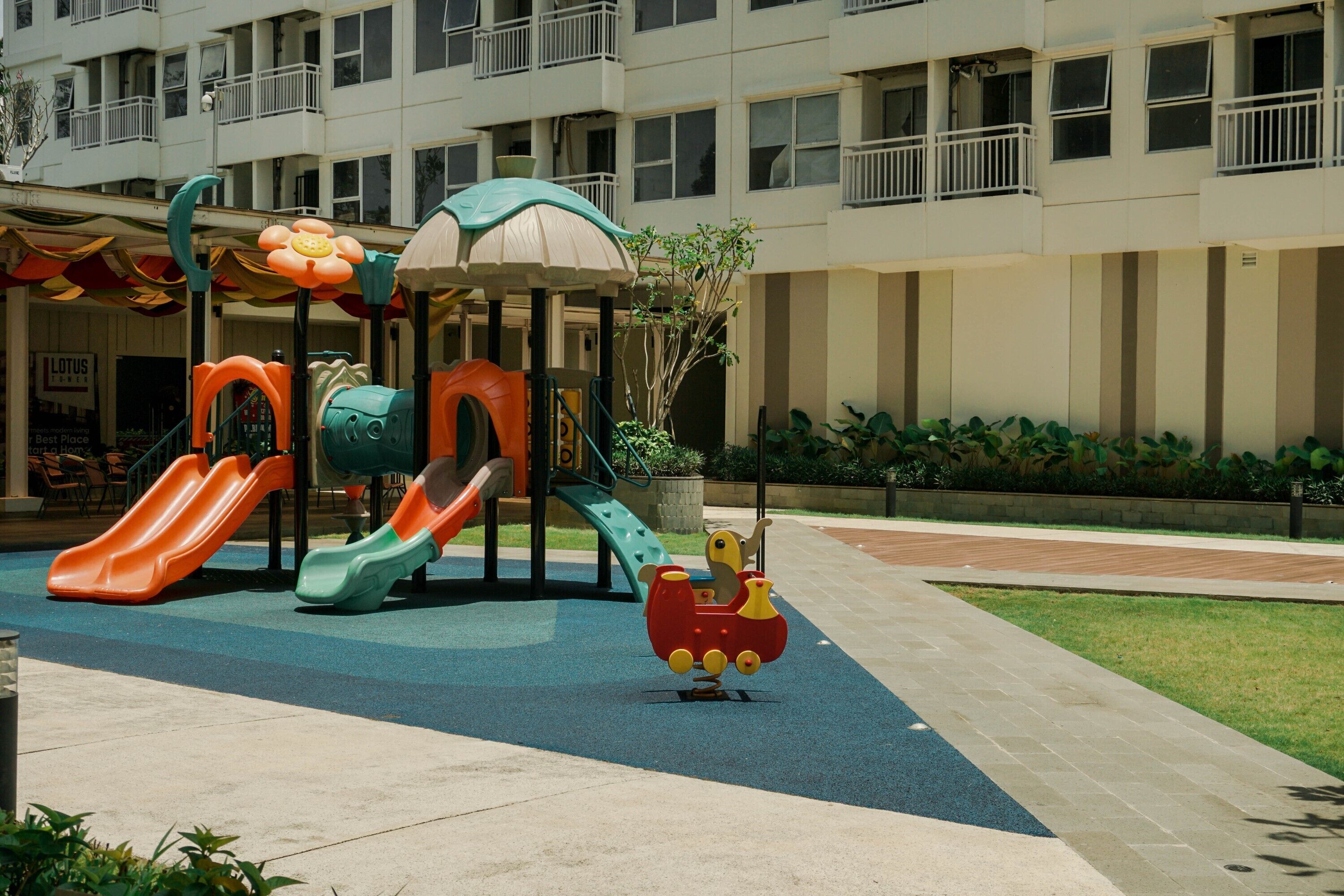 A children's play area with slides and a ride-on toy.