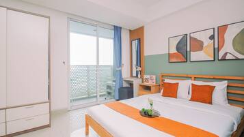 Ein Hotelzimmer mit Bett, Nachttisch, Spiegel und Bildern an der Wand.