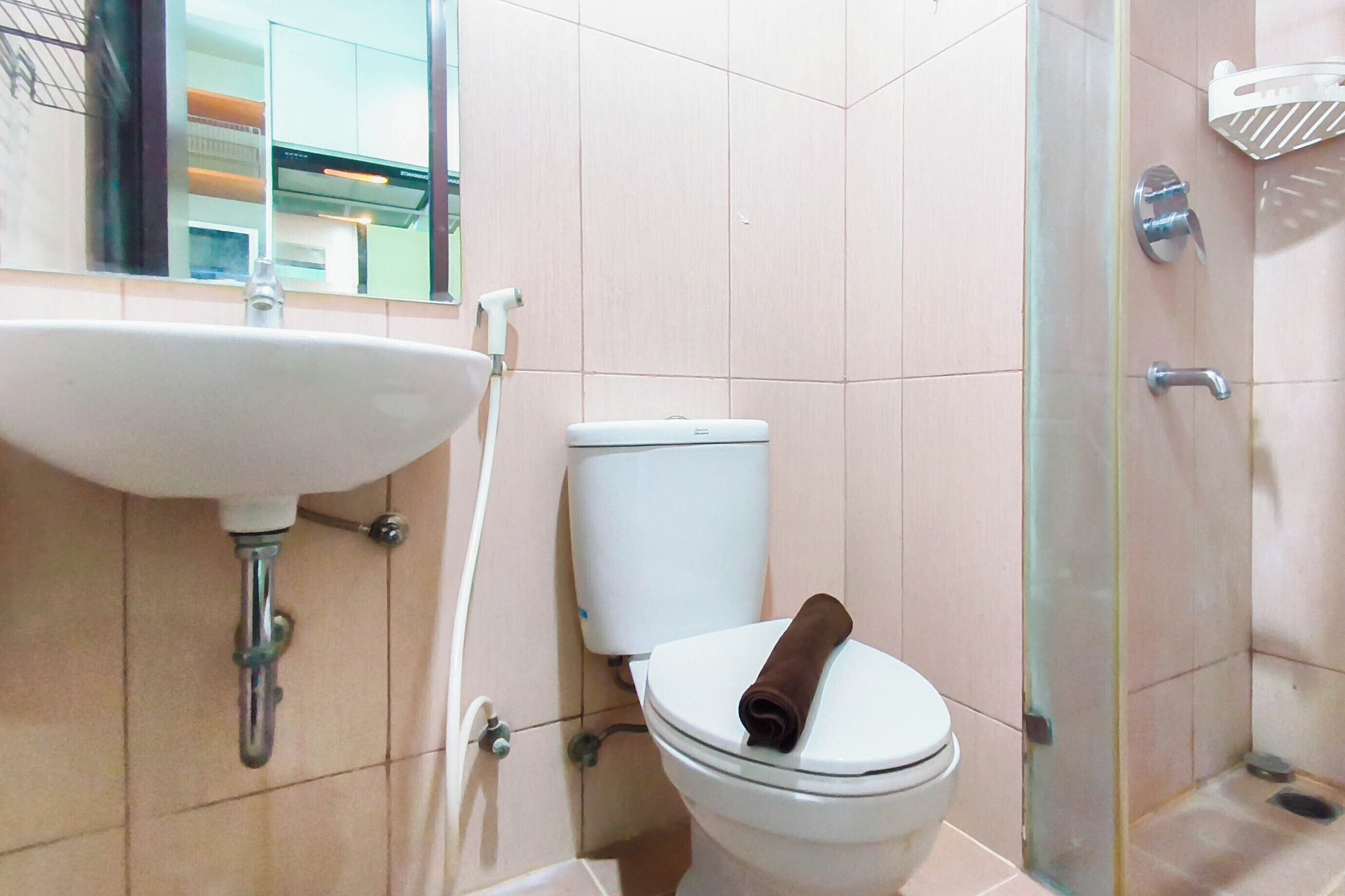 A bathroom with a sink, toilet, and shower area.