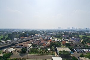 A residential area with houses, a highway, and distant buildings.