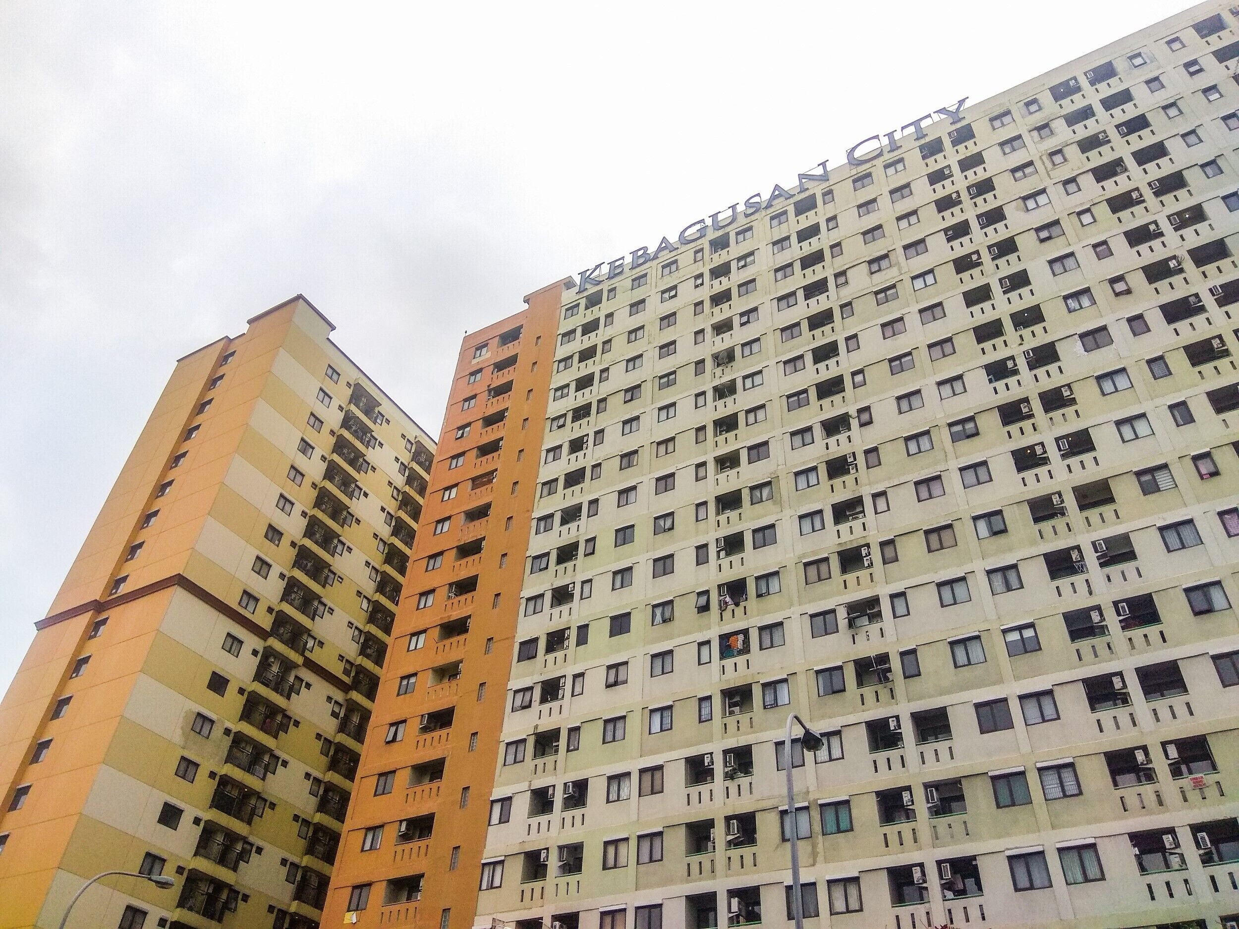 A high-rise building with multiple balconies and a uniform facade.