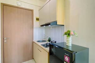A compact kitchen with a gas stove, a sink, and a built-in oven.