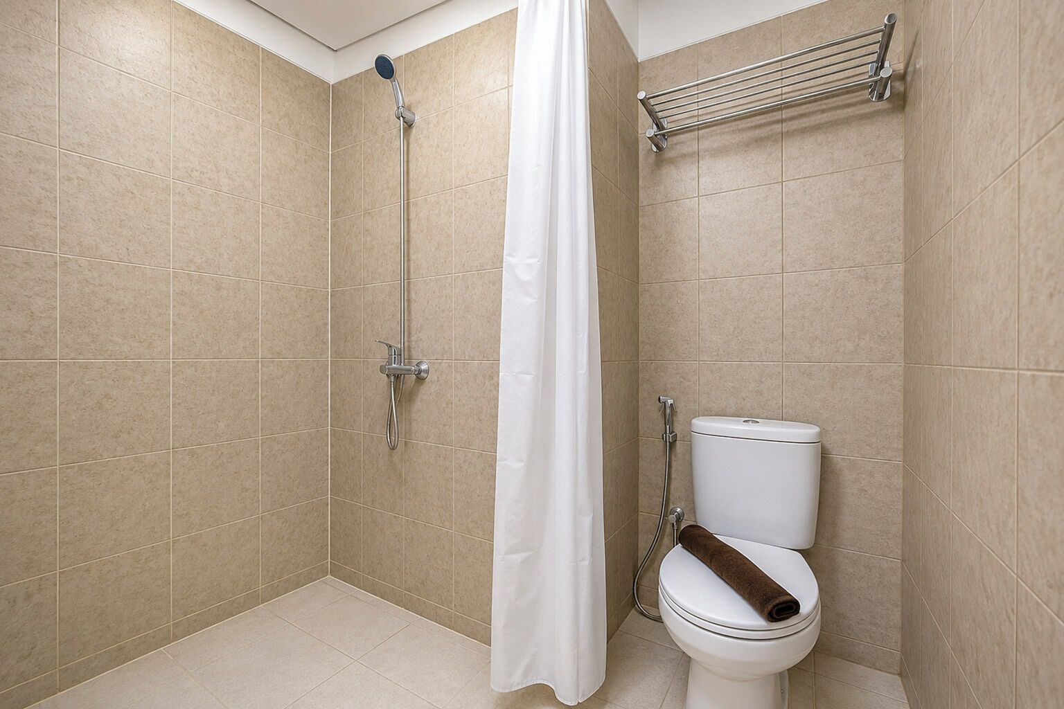 A bathroom with a shower, toilet, and a towel rack.