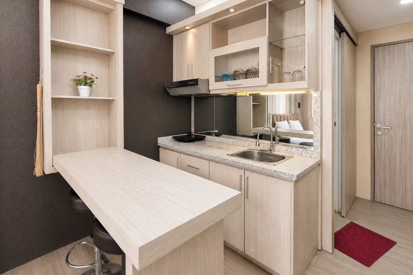 A modern kitchen with a countertop, sink, and cabinets.
