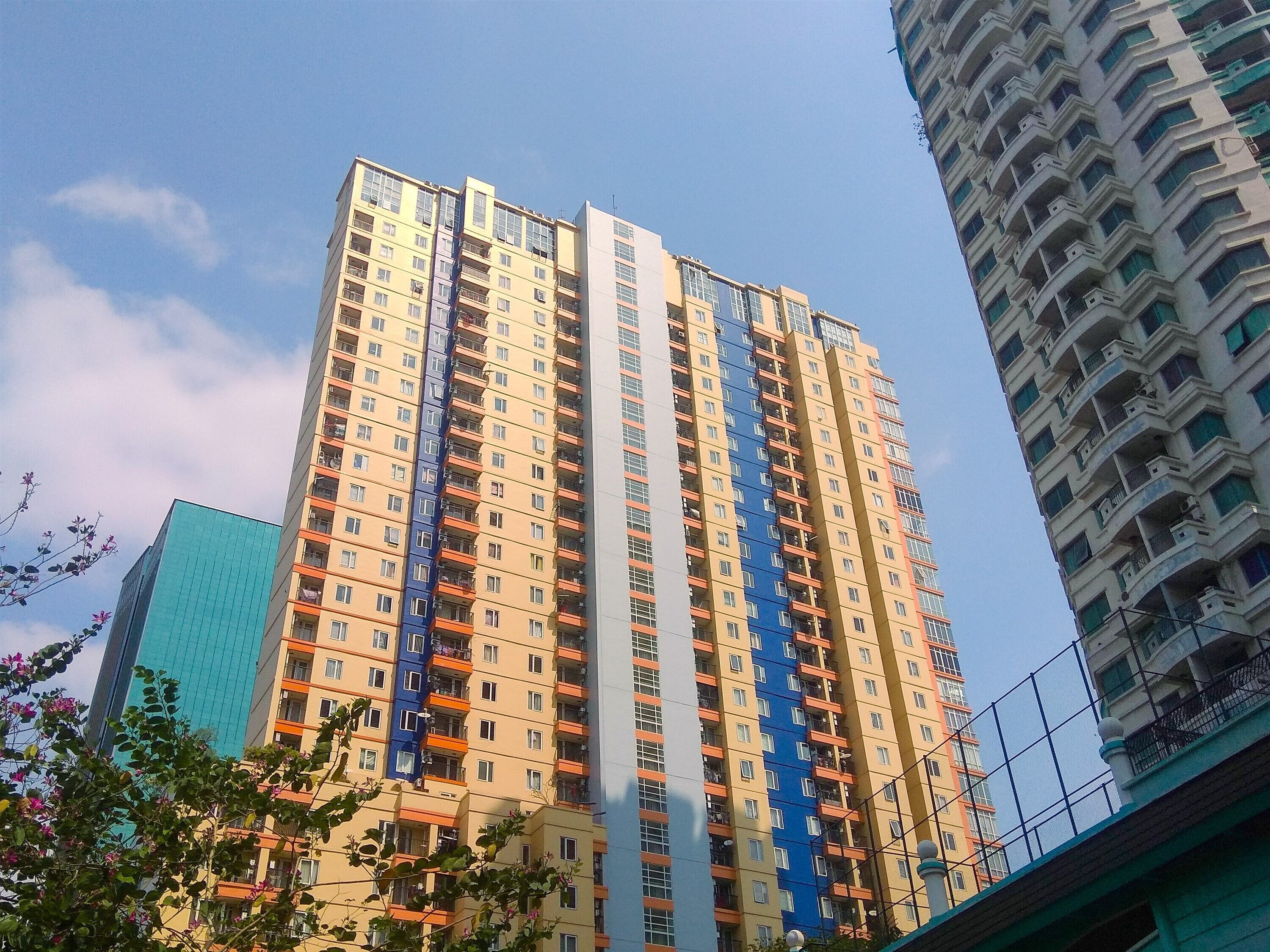 A high-rise building with multiple balconies and a modern architectural design.