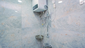 A bathroom with a built-in water heater, a showerhead, and a handheld shower attachment. - Elegant & Cozy Living 2Br Boutique Kemayoran Apartment Next To Citra Xperience Mall (Jakarta)