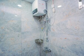 A bathroom with a built-in water heater, a showerhead, and a handheld shower attachment. - Elegant & Cozy Living 2Br Boutique Kemayoran Apartment Next To Citra Xperience Mall (Jakarta)