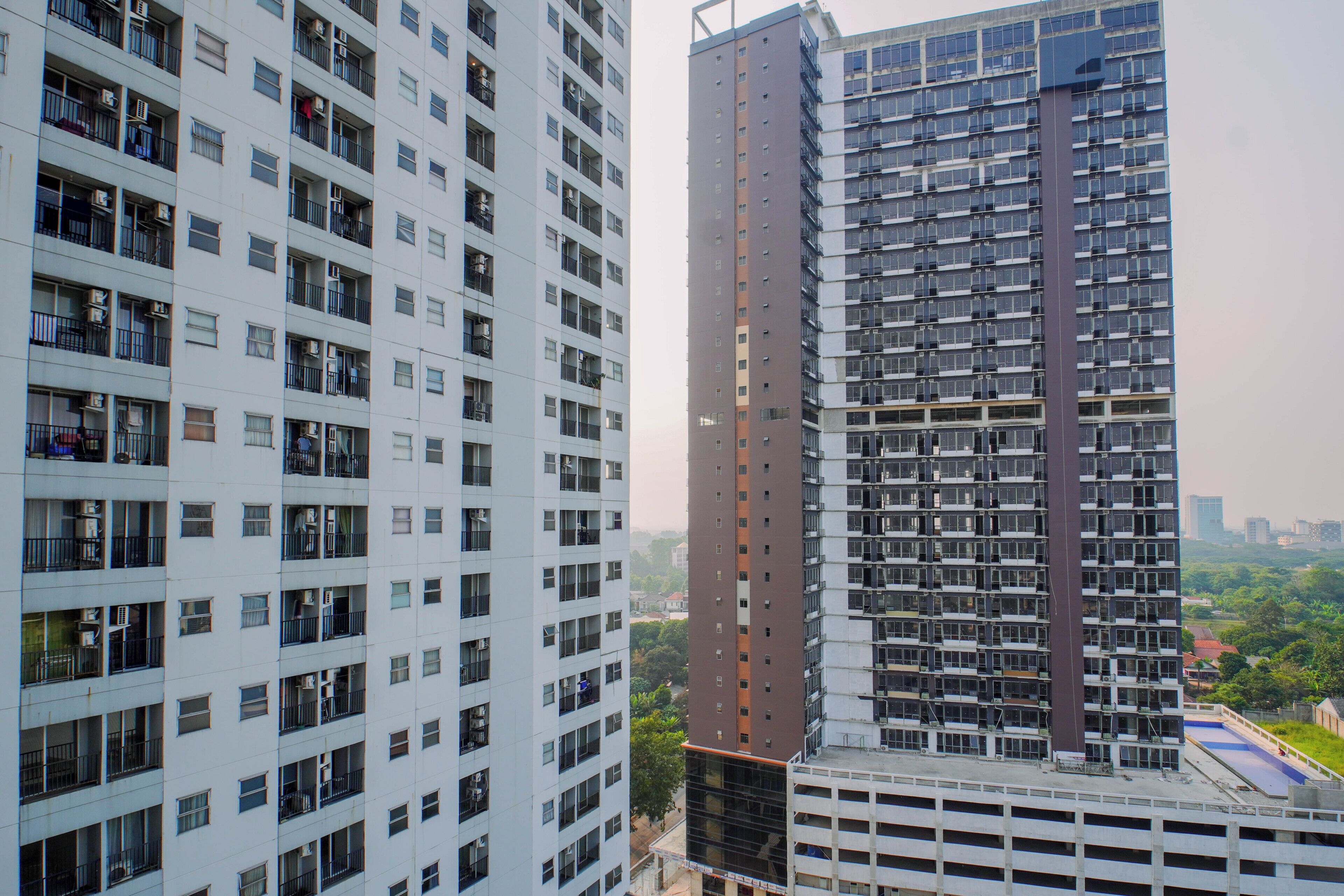 A high-rise building with multiple floors, balconies, and a mix of residential and commercial spaces.