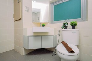 A bathroom with a toilet, sink, and shower. - Smart Value 2Br At Apartment Pejaten Park Residence (Jakarta)
