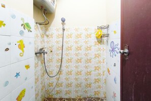 A bathroom with a shower, tiled walls with a floral pattern, and a door with a handle. - Warm Homey 2Br At Apartment Gateway Ahmad Yani Cicadas (Bandung)