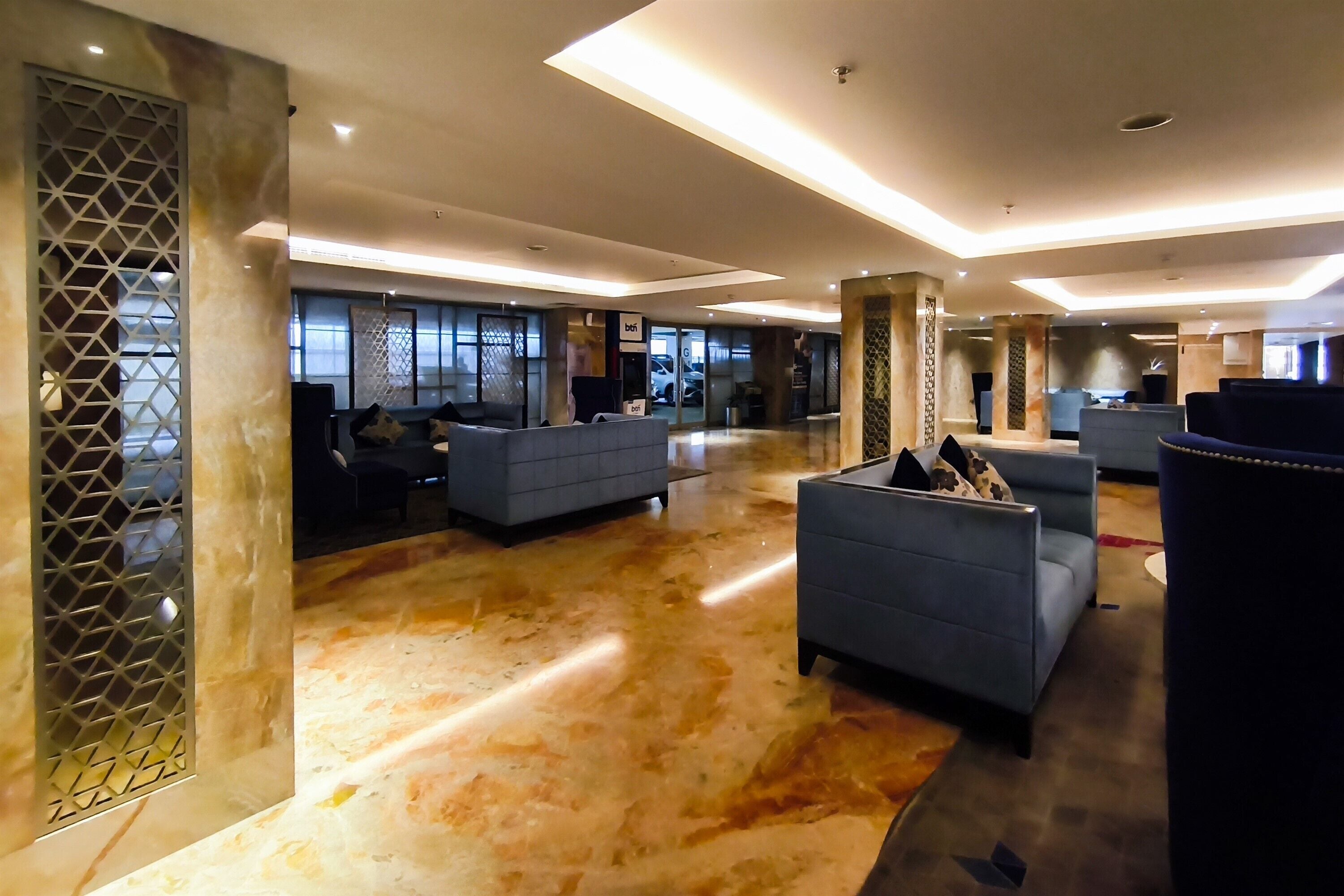 A spacious lobby with seating areas and a reception desk.