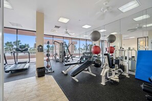 A gym with treadmills, weight machines, and exercise balls. - 🌞CBC 1-15A – Water views from every window! 5 balconies, heated pool, pickleball, gym. (Clearwater Beach)