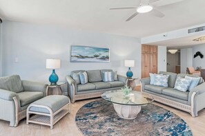 A living room with two sofas, a coffee table, and two lamps. - 🌞CBC 1-15A – Water views from every window! 5 balconies, heated pool, pickleball, gym. (Clearwater Beach)