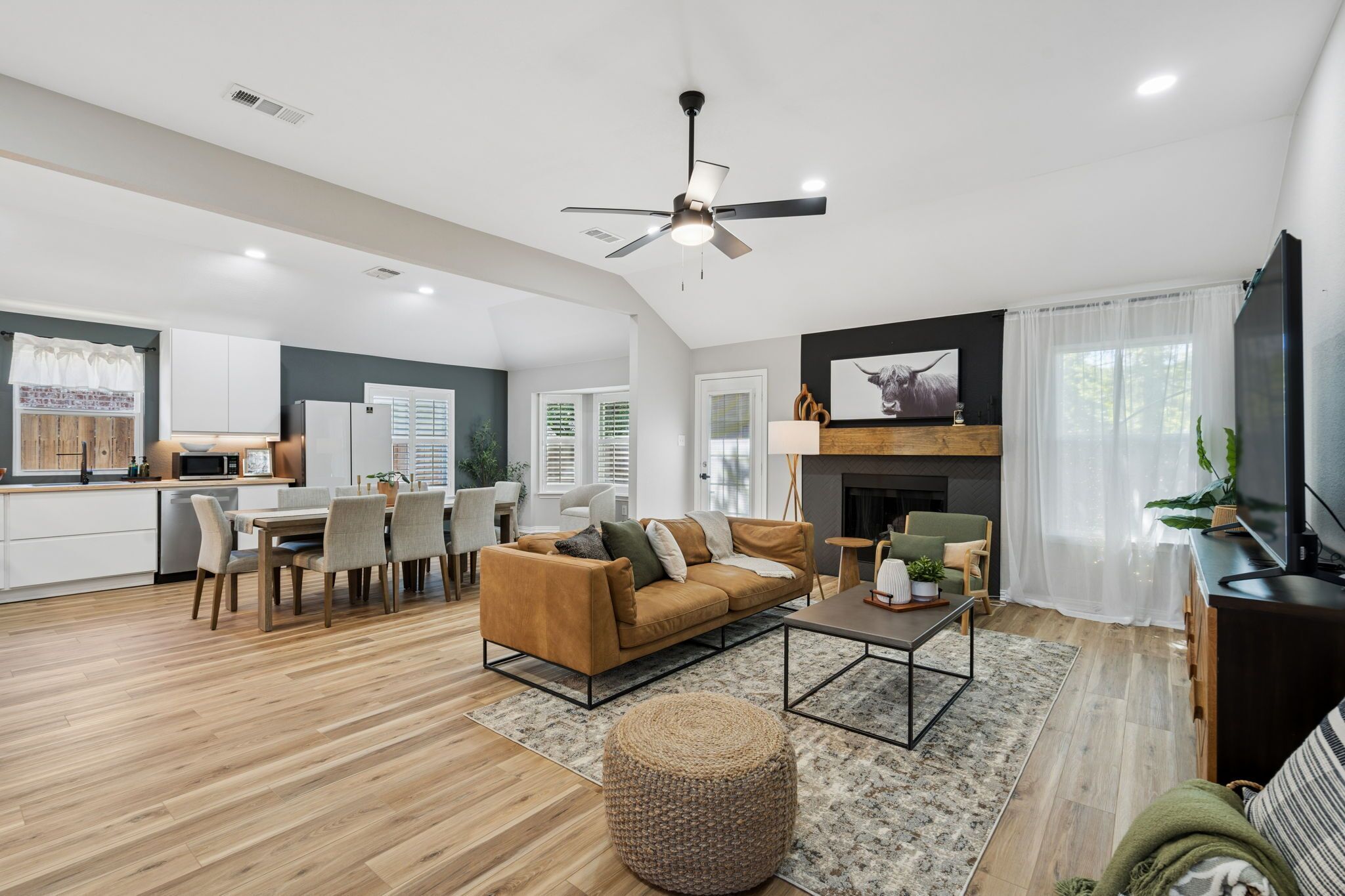 A spacious living area with a sofa, coffee table, and a television.