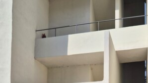 A multi-level building with a staircase leading to an upper floor.