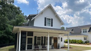 A two-story house with a covered porch and a garage. - 3-Bdrm Oxford Home Away From Home 6 mins to The Square, 3.9 miles to The Stadium (Oxford)