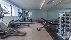 A gym with treadmills, elliptical machines, a stationary bike, and a rack of dumbbells. - Smart Compact Two Bedrooms 2 Bath & Two Balconies (Auckland City)