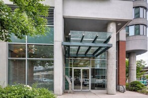 A modern building entrance with a glass door marked '688' and a covered entrance area. - Downtown Vancouver, Sleeps 7, Pool & Hot Tub (Vancouver)