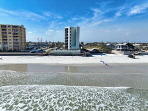 A beachfront hotel with a pool, a beach, and a pier. - Ocean Trillium 604 - Beautiful Beachfront Condo in New Smyrna Beach with Oceanfront Pool (New Smyrna Beach)
