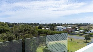 A residential area with houses, trees, and a clear sky. - Salt At East - Top Floor (Port Fairy)