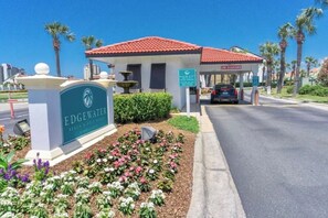 A building with a red-tiled roof, a sign reading "EDGEWATER BEACH & GOLF RESORT," and a parking area with a car. - Bright, Updated Love's Coastal Villa Retreat w/ Heated Pool & Resort Perks (Panama City Beach)