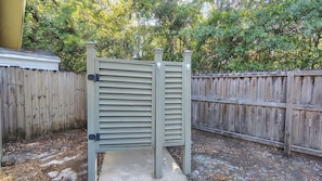 A wooden fence with a metal gate in a backyard. - " Tiny Getaway " 2 Bedrooms 1 Bath Home (Supply)