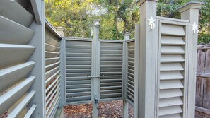 A gated outdoor area with a metal gate and a wooden fence. - " Tiny Getaway " 2 Bedrooms 1 Bath Home (Supply)