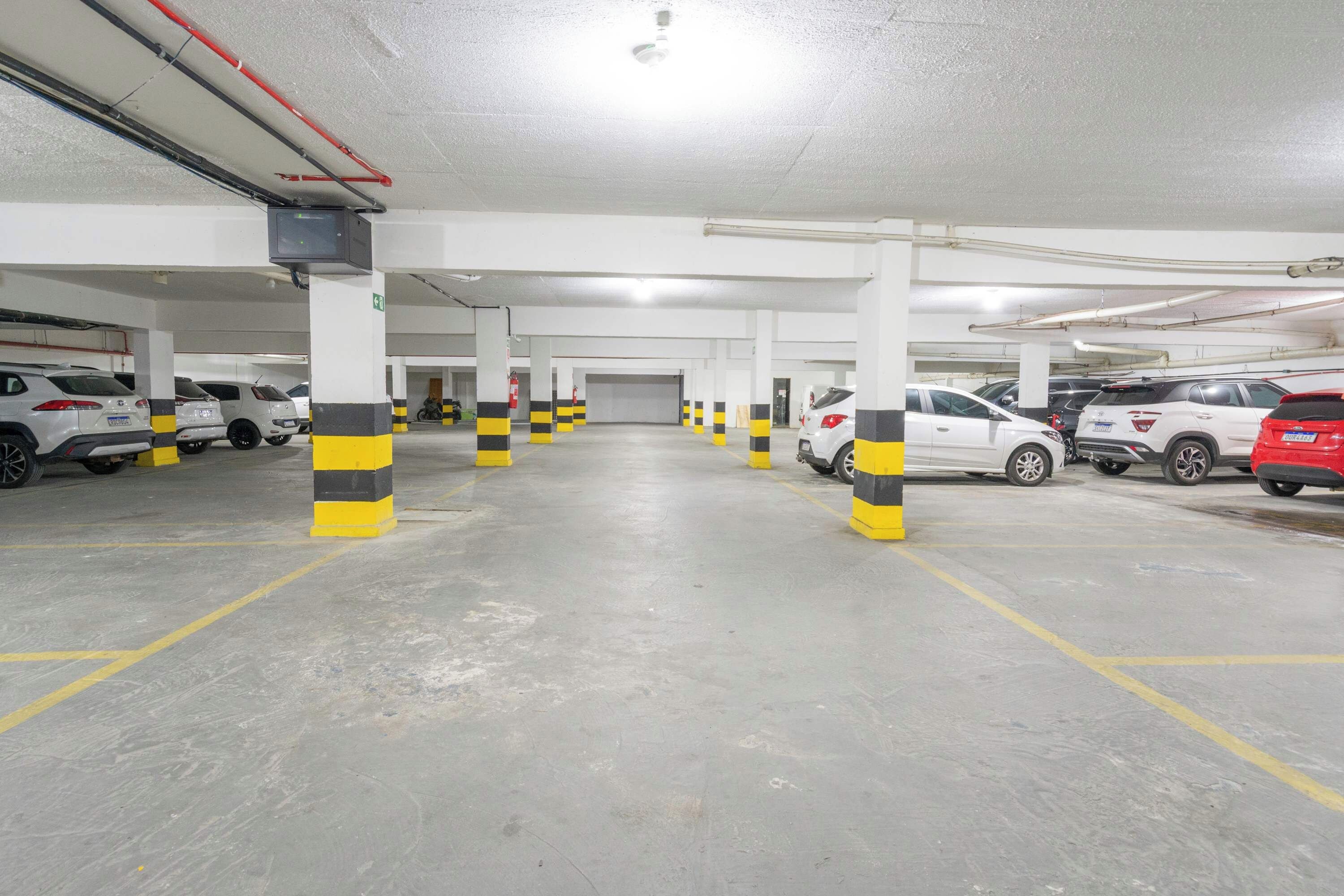 A multi-level parking garage with several cars parked.
